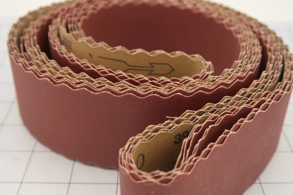 2 X 72" HOG BRAND SCALLOPED "J" FLEX ALUMINUM OXIDE SANDING BELTS rolled for easy storage