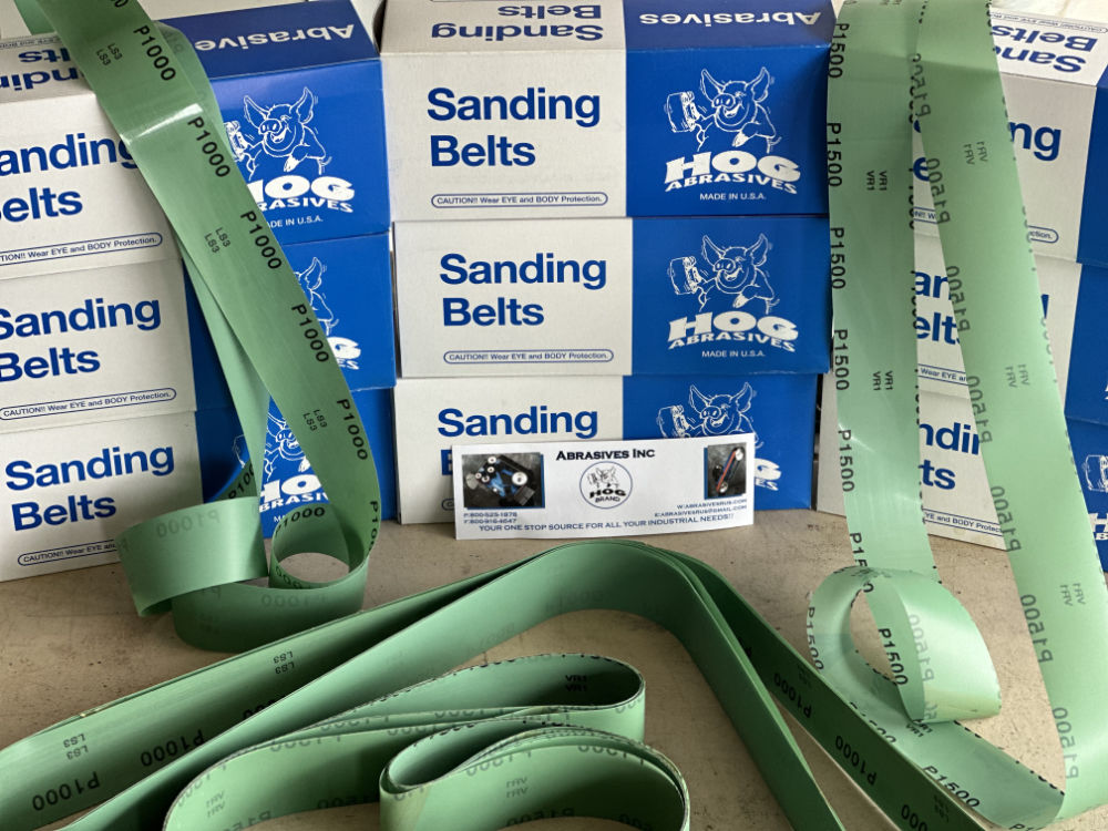 2″ x 72″ Hog Brand Film Micron Green Ultimate Mirror Finish Belts on display with packaging and branding visible.